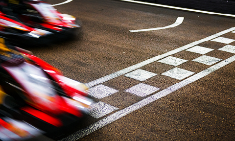 race cars driving over the finish line